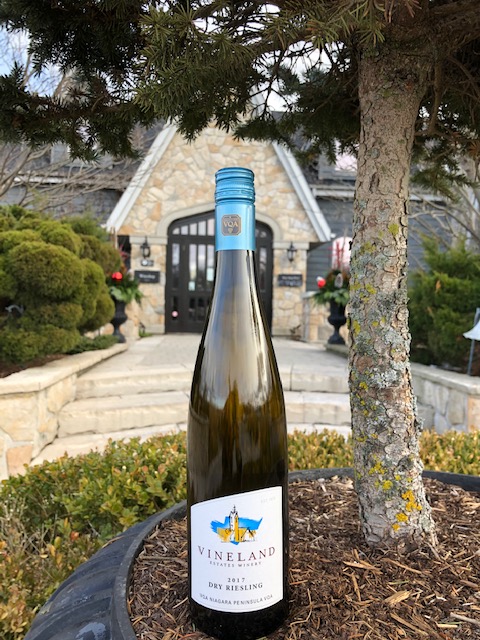 Vineland Estates Dry Riesling bottle in front of wine entrance