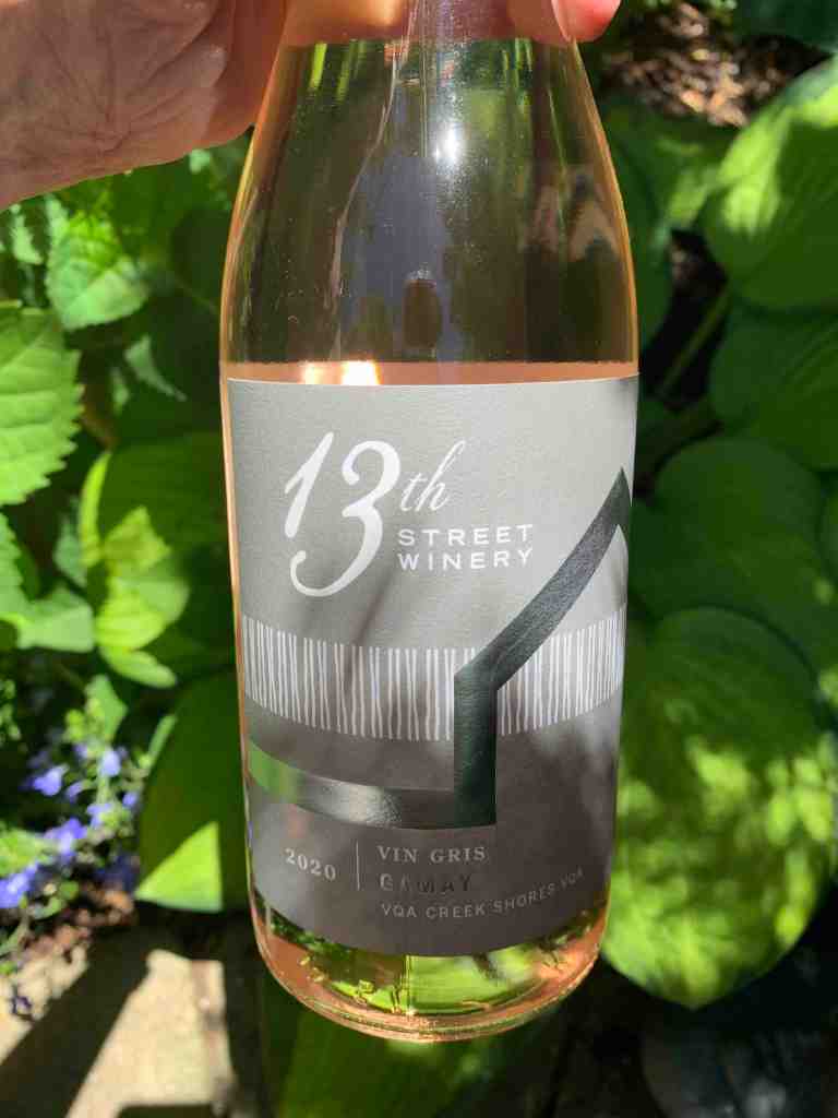 Bottle of 13th Street Gamay wine in garden