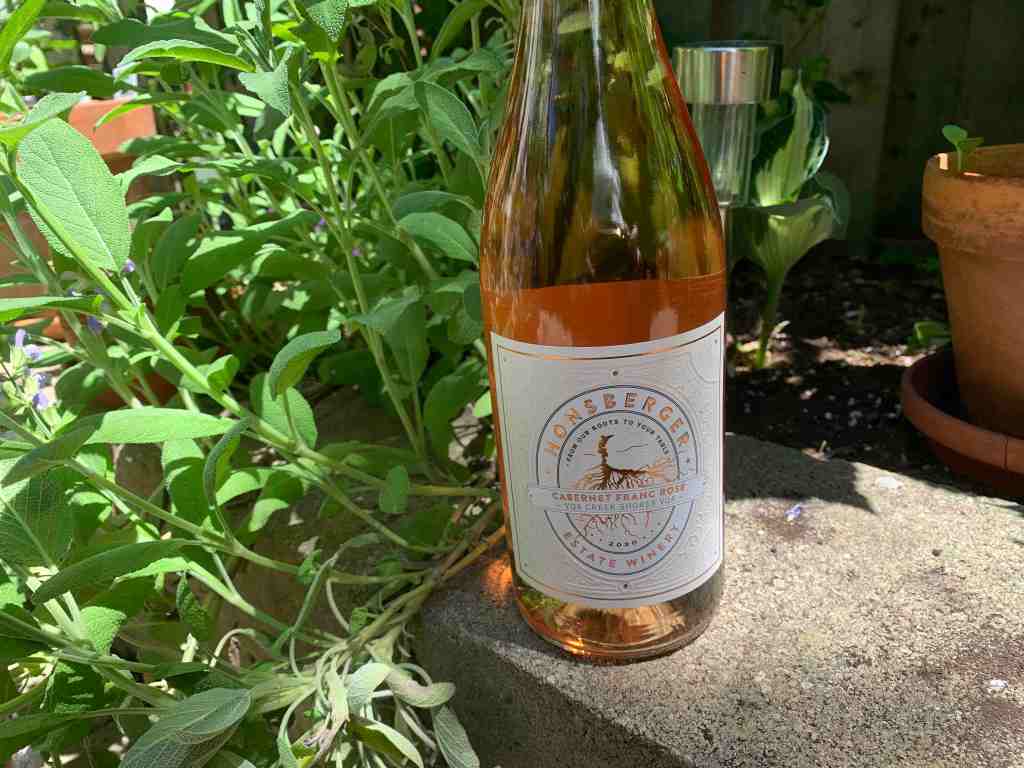 bottle of Honsberger wine sitting on garden ledge