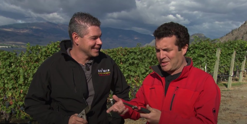 Comedian Rick Mercer joking with winemaker Justin Hall in vineyards